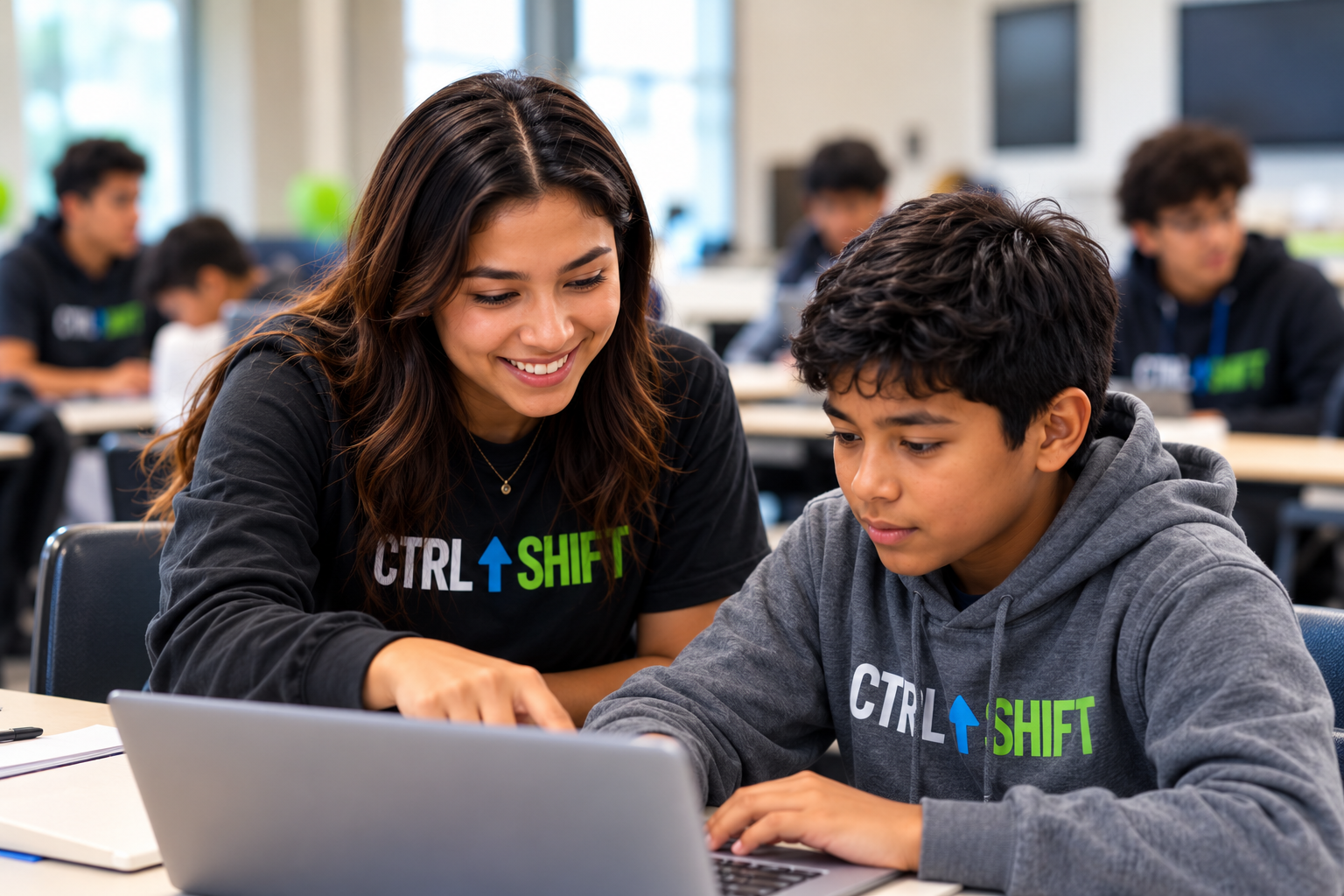 College mentor guiding a Chicago youth through a laptop activity